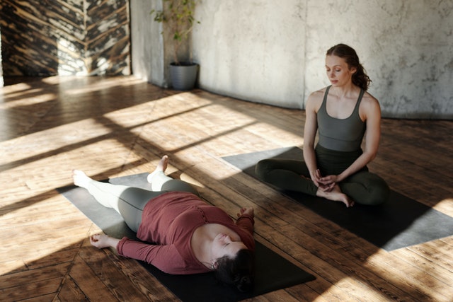 two woman on yoga mats